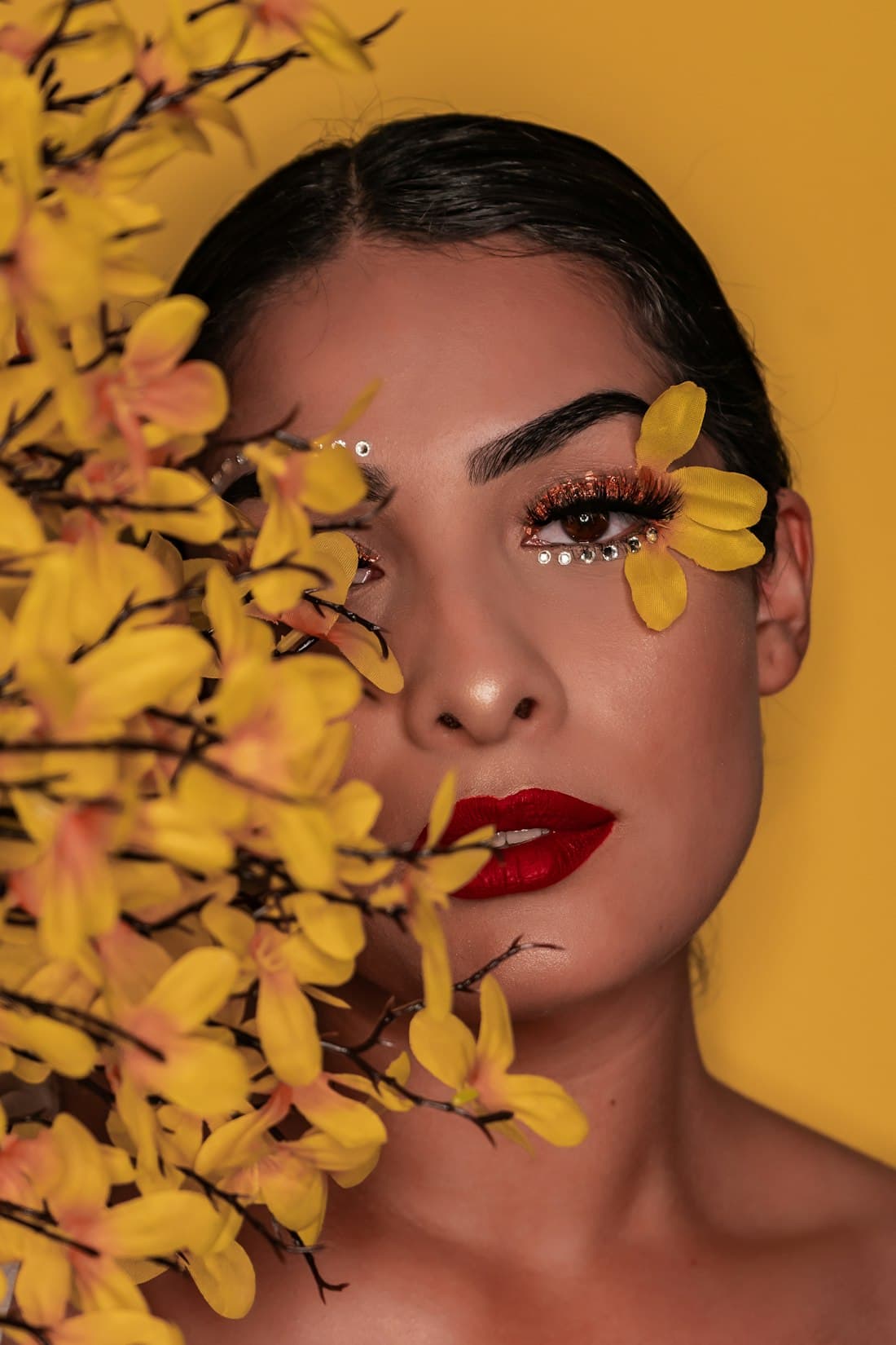 Model with bold eye makeup and red lips