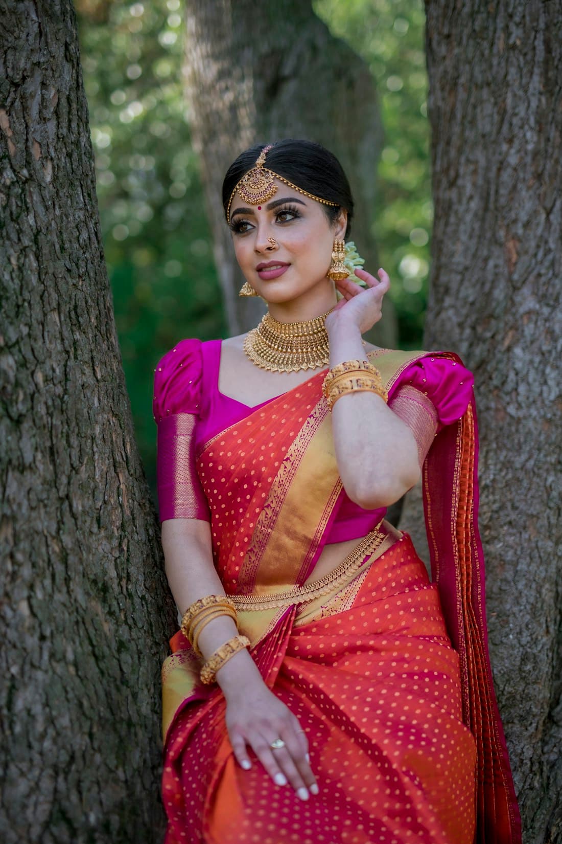 Woman in a red and pink Banarasi saree
