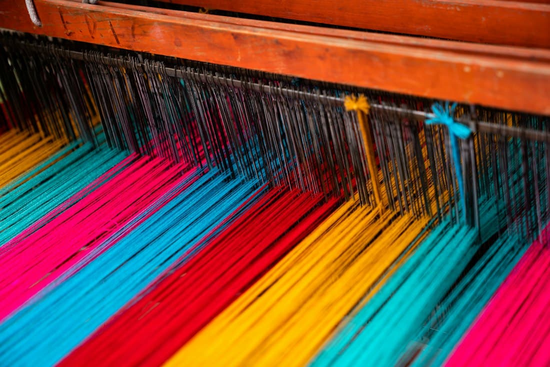 Bright threads stretched across a loom